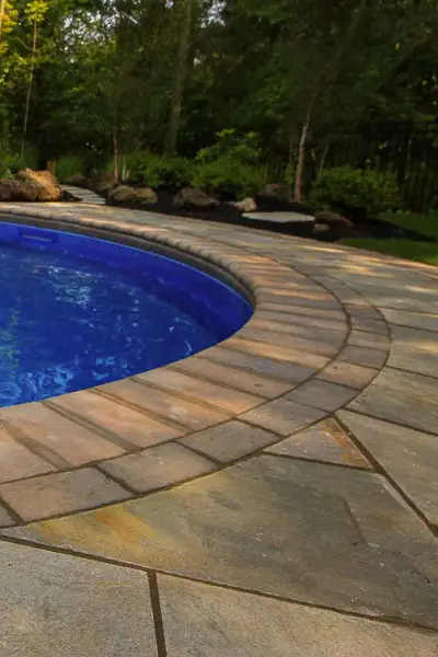 Landscaping and patio around a pool