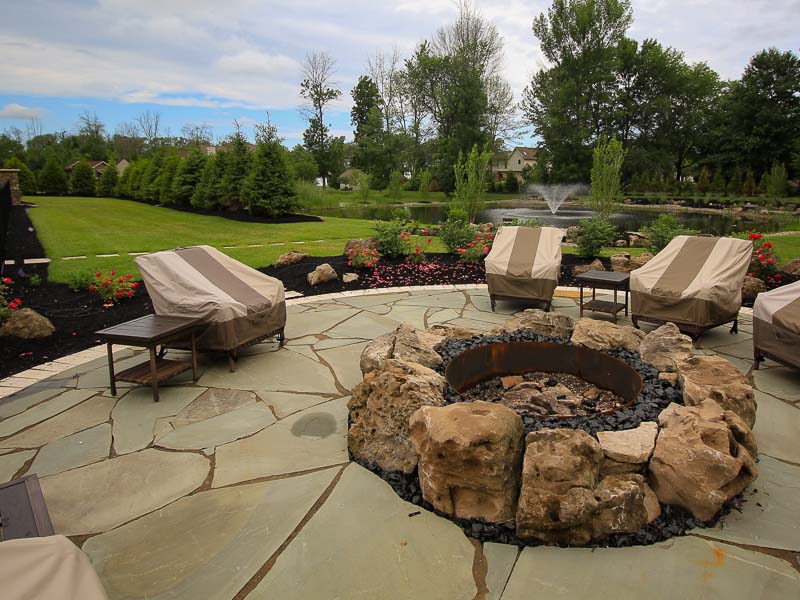 Outdoor Living area includes a fire pit and natural stone patio