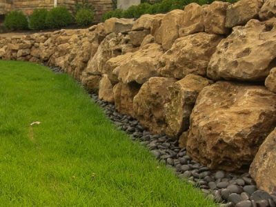 Boulders used as a retaining wall in Rochester NY