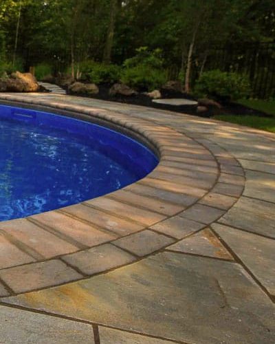 Landscaping and patio around a pool